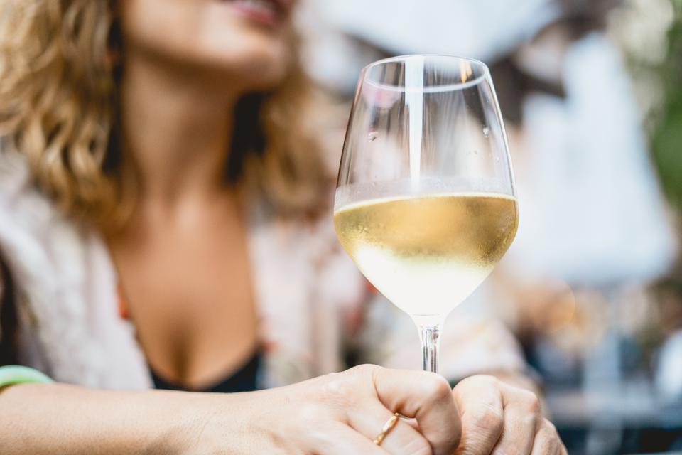 Midsection Of Woman Holding Wineglass