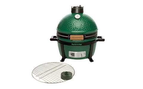 Big Green Egg charcoal BBQ with griddle and black handles and temperature checker 