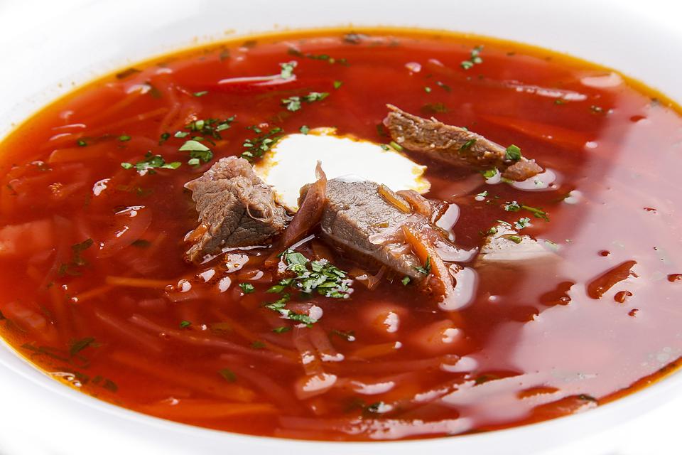 Ukrainian borscht with veal on a white background. Traditional dish